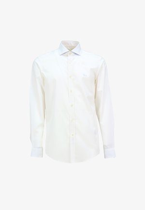 Bílá dlouhá košile s kravatu, vpředu s knoflíky a s vyšitým světle modrým logem na hrudi. Hladký bavlněný materiál.