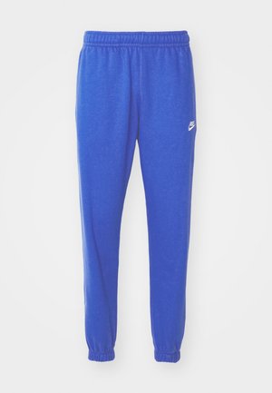 Blue athletic pants made of textured fabric, featuring an elastic waistband and ankle cuffs, with a small white Nike logo on the side.