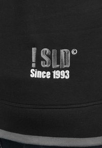 Schwarzer Sweatshirt mit gesticktem Text "! SLD" und "Since 1993" in Grau. Enthält graue Akzente am Saum und an den Bündchen.