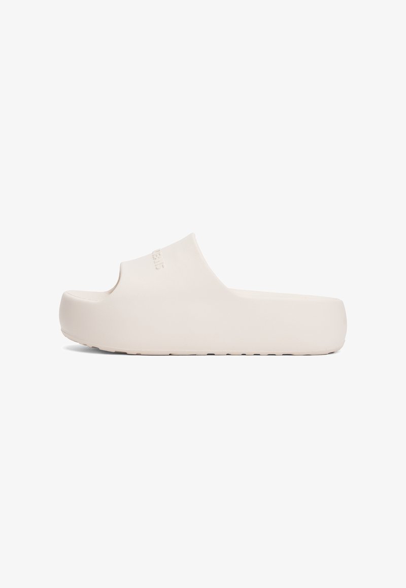 Beige instapsandaal van glad rubbermateriaal, open teen en een dikke zool. Minimalistisch ontwerp zonder zichtbare versieringen of patronen.