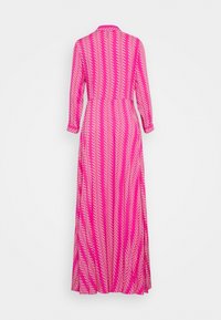 Maxi dress in bright pink fabric features a white zigzag pattern, long sleeves, a collared neckline, and a flowing A-line silhouette.