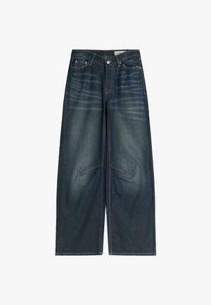 Jeans in denim scuro a gamba larga con un motivo sbiadito, cuciture visibili, tasche frontali e chiusura con zip.