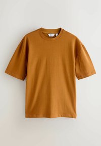 Brown cotton t-shirt featuring a round neck, short sleeves, and a relaxed fit. Smooth texture with no patterns or embellishments.