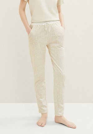 Cremefarbene Jogger-Hosen mit geometrischem Muster, ausgestattet mit einem elastischen Bund mit Kordelzug und seitlichen Taschen. Glatte Textur.