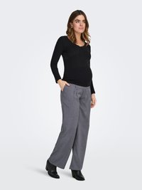 Long-sleeve black ribbed top with a scoop neckline, paired with light gray wide-leg trousers and black heeled ankle boots.