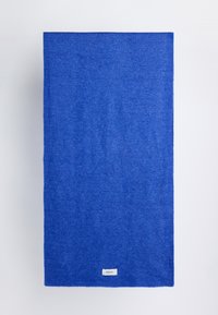 Blue wool blanket featuring a smooth texture, rectangular shape, and a small label at the bottom corner. Edges are finished with a knit pattern.
