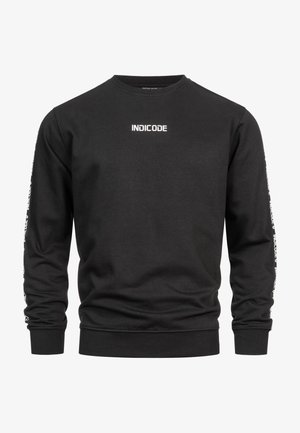 Black sweatshirt made of cotton, featuring a crew neck, long sleeves, and the word "INDICODE" printed in white on the chest and sleeves.