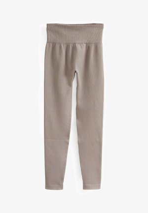 Leggings beige à côtes avec une large ceinture, des jambes fuselées et une texture lisse, conçues pour le confort et la flexibilité.