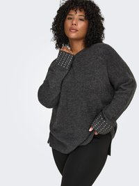 Dark gray knitted sweater with a V-neck, ribbed hem, and embellished sleeves featuring silver studs. Soft texture, relaxed fit.