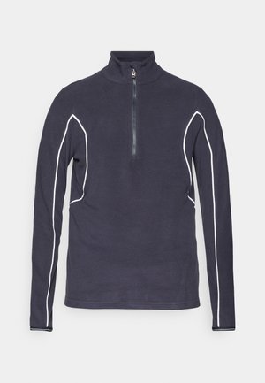 Marineblauer Fleece-Pullover mit Reißverschluss und hohem Kragen, ausgestattet mit weißen Kontrastnähten entlang der Nähte und einem metallischen Reißverschluss. Glatte Textur.