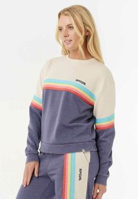 Lila- und cremefarbener Pullover mit mehrfarbigen horizontalen Streifen über der Brust. Mit Ripcurl-Logo auf der Vorderseite und gerippten Bündchen.