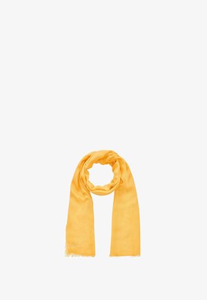 Écharpe légère jaune avec bords à franges, bouclée librement en cercle sur fond blanc.