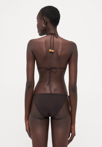 Bruine bikini met een halternekontwerp, verstelbare strikjes en decoratieve kralen op de rug. Gladde textuur en minimalistische stijl.