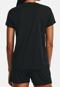 Black athletic t-shirt made of smooth, lightweight fabric with short sleeves and a curved hem, paired with matching black shorts.