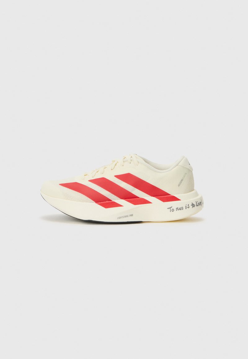 Running shoes with a cream upper, red diagonal stripes, a smooth texture, and a notable inscription on the outsole: "To run is to live!"