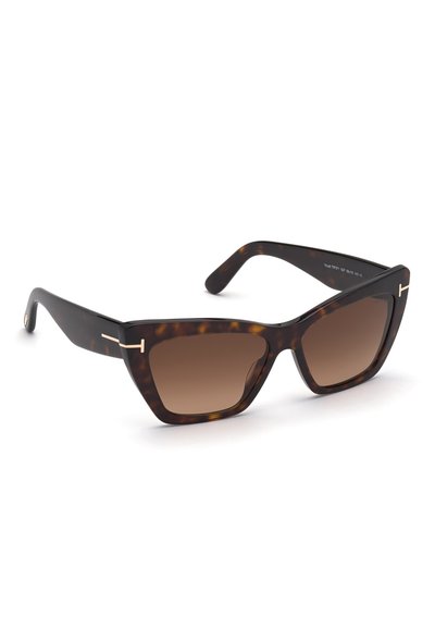 Gafas de sol de carey con un marco geométrico, lentes marrones degradados y detalles en tono dorado en las patillas.