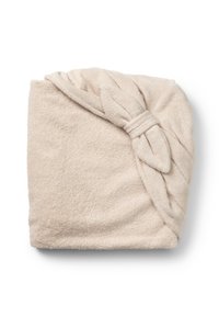 Mjuk beige handduksscarf med en knuten rosett detaljer. Tillverkad av texturerad frotté, den har en rektangulär form och en lyxig finish.
