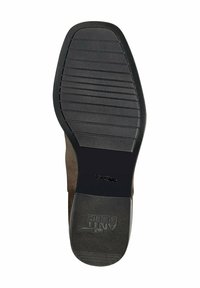 Suela de zapato de goma negra con un agarre texturizado, que presenta surcos horizontales y verticales, así como un logo en relieve, diseñada para la durabilidad y la tracción.