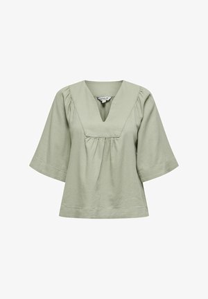 Jasnozielona bluzka z dekoltem w kształcie litery V, krótki rękaw i marszczeniem w talii. Wykonana z miękkiego materiału, charakteryzująca się luźnym krojem.