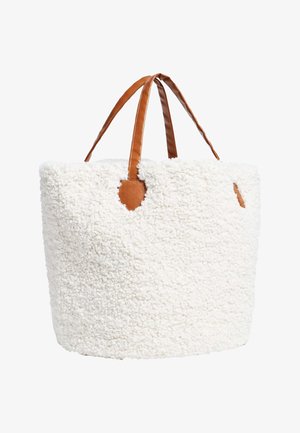 Kremfarvet tekstureret taske med brune læderhåndtag og kant, med en blød, fluffy yderside.