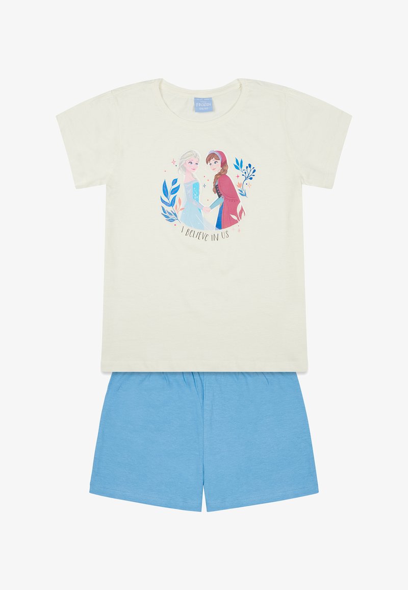 Camiseta de manga corta color crema con un gráfico de dos personajes y "CREO EN NOSOTROS", combinada con pantalones cortos azules de material de algodón suave.