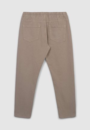 Jasno beżowe spodnie z elastycznym paskiem, dwoma tylnymi kieszeniami i zwężającym się krojem nogawki. Wykonane z miękkiego, strukturalnego materiału.