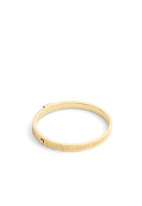 Gold-colored bangle bracelet featuring a smooth surface with textured vertical lines along the outer edge. Hinged clasp for opening.