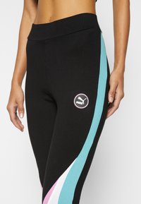 Puma leggings i svart tyg med hög midja, med sidostripes i teal, rosa och vitt, samt en rund logotypapplikation på låret.