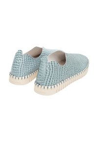 Light blue slip-on shoes made of textured material, featuring a scalloped design, a contrasting white sole, and visible stitching.