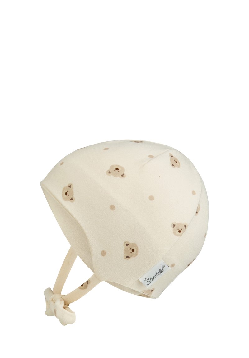 Cream baby bonnet with small brown bear faces and dots pattern, featuring chin straps tied in a knot and a white Sterntaler label.