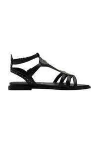 Black sandals featuring a sleek, strappy design made of leather. Accented with metallic studs and a flat sole, providing a minimalist look.