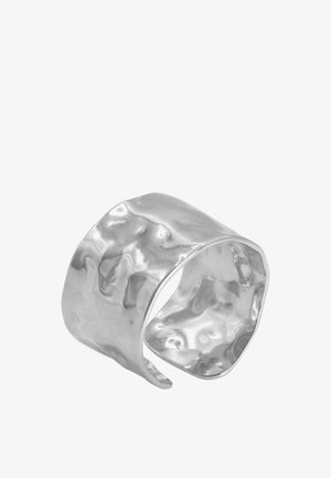 Anello a manica ondulata in argento, realizzato in metallo lucido con una texture spazzolata e una forma irregolare, caratterizzato da bordi lisci e una fascia ampia.