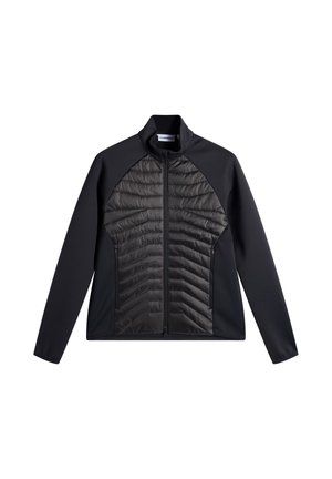 Veste noire avec panneau avant matelassé, fermeture éclair complète, col montant, manches et côtés en tissu lisse, posée à plat sur fond blanc.