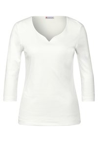 Maglietta bianca a maniche lunghe con scollatura a V, realizzata in morbido cotone. Presenta una forma aderente senza motivi o elementi hardware visibili. Texture liscia.