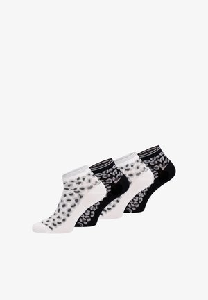 Vier Paar Knöchelsocken, abwechselnd schwarz und weiß mit kontrastierendem Leopardenmuster auf weißem Hintergrund.