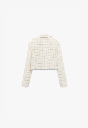 Veste raccourcie en tissu texturé blanc avec un motif à carreaux, dotée de manches longues et d'un col à revers.