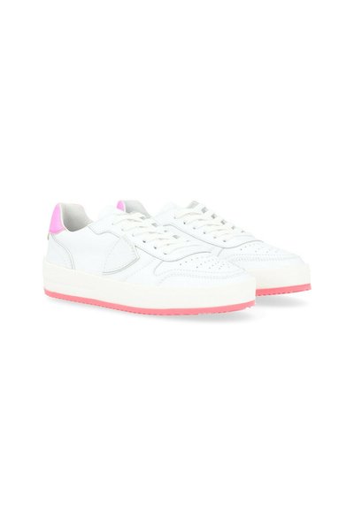 White leather sneakers with pink accent on the heel, perforated toe, and a thick white sole. Features flat laces and a simple design.