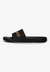 Black slide sandal with a wide strap featuring gold lettering. Smooth texture with a flat sole and subtle branding on the side.