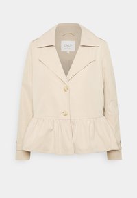 Beżowa kamizelka peplum z gładkiego materiału, z wyciętym kołnierzem, dwoma guzikami oraz długimi rękawami z zapięciem na guziki.