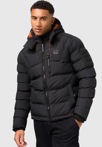 Schwarze Pufferjacke mit verstellbarem Kapuzenbereich, Reißverschluss vorne und orangefarbenen Zugbändern. Enthält eine Brusttasche und gerippte Bündchen.