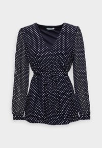 Námořnická modrá blůza s dlouhým rukávem a bílými puntíky, véčkový výstřih, průhledné rukávy a pásek na zavázání v pase.