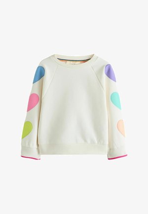 Cremefarbener Sweatshirt mit langen Ärmeln, bunten herzförmigen Applikationen auf beiden Ärmeln und pinker Einfassung an den Bündchen.