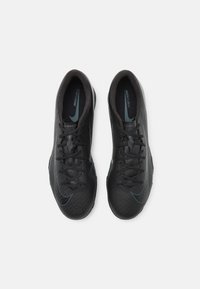 Black athletic shoes with textured uppers, featuring a contrasting teal accent. Designed for sports, with a sleek, streamlined shape.