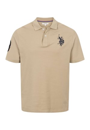 Šviesiai rudos spalvos trumpomis rankovėmis polo marškinėliai su dviem mygtukais, apykakle, tamsiai mėlynu siuvinėtu polo žaidėjo logotipu ant krūtinės ir skaičiaus ženkleliu ant rankovės.