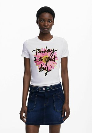 Una camiseta blanca de manga corta, con un diseño colorido de flores y el texto "Hoy es un buen día". Llevada con una falda de mezclilla oscura.