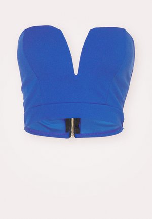 Top corto blu con una scollatura a V profonda, dotato di una chiusura con zip sul retro e una consistenza di tessuto liscia e elasticizzata.