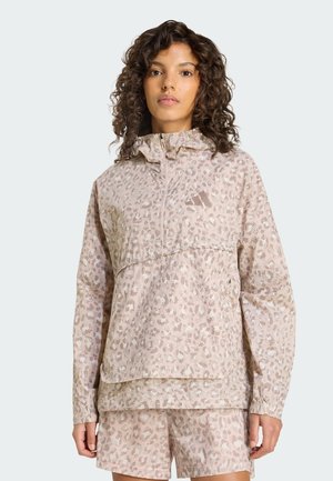 Kevyt hupullinen pusero beigen ja vaaleanpunaisen eläinkuosilla, vetoketjullinen, kuminauhakärjillä ja rennolla istuvuudella.