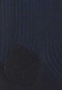 Calzini a coste di colore blu scuro con sottili strisce di un blu più chiaro, caratterizzati da una texture liscia e un'area rinforzata nella punta, realizzati in un tessuto elastico.