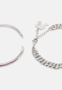 Silver bangle featuring a pink crystal stripe and a silver chain bracelet with links interspersed with small clear crystals and a clasp.