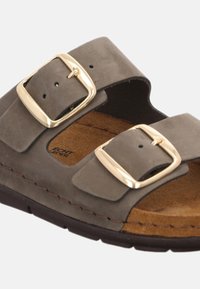 Grå mockasandal med två justerbara remmar och guldfärgad spänne, med en brun dämpad innersula och strukturerad gummiyttersula.